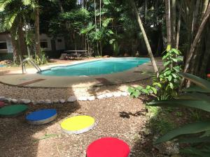 a swimming pool with colorful stepping stones around it at CulturaHumana Guesthouse in Panama City