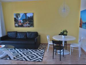 a living room with a couch and a table and chairs at Cima Caravina in Cima