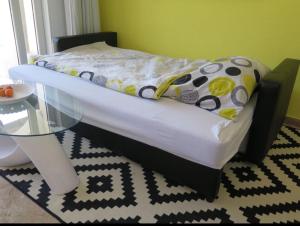 a bed in a room with a glass table at Cima Caravina in Cima