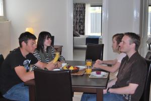 a group of people sitting around a table at Brayfield Cottage in Murray Bridge