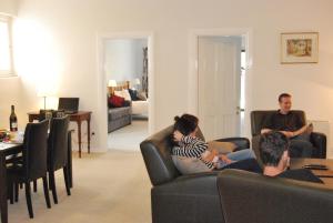 a group of people sitting in a living room at Brayfield Cottage in Murray Bridge