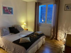 a bedroom with a large bed with a window at SARL l'Alzina in Vernet-les-Bains