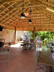 a wooden table and chairs under a wooden roof at Bella Vista Vacation in Montego Bay