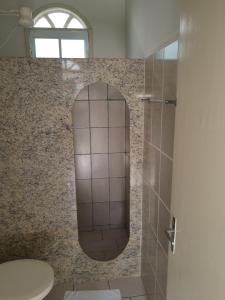 a bathroom with a mirror and a toilet at Vista Oceanica Pousada in Marataizes +26 photos