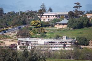 a large building on a hill next to a road at Brayfield Cottage in Murray Bridge
