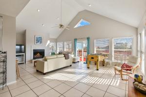 a living room with a couch and a fireplace at The Vista of Palm Beach in Galveston