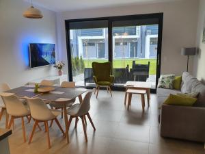 a living room with a table and chairs at Aprum Apartments 10C in Pobierowo