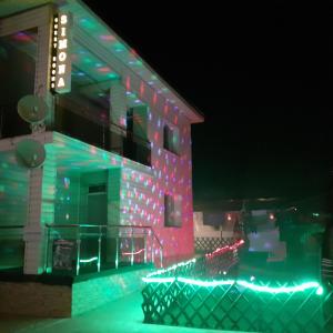 a building with christmas lights on the side of it at Guest Rooms Simona in Opanets