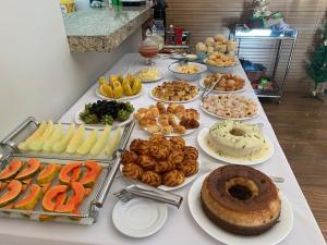 a table with many different types of food on it at Pousada Morro do Frota in Pirenópolis