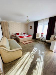 a living room with a bed and a couch at Casa Elena in Sibiu