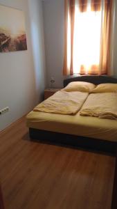 Postel nebo postele na pokoji v ubytování Jenny apartman Siófok