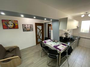 a kitchen and living room with a table and chairs at Apartament Sulina in Sulina