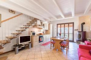 a living room with a table and a staircase at Casa Vacanze Rosalba in Ferraro di Monte Baldo +16 photos