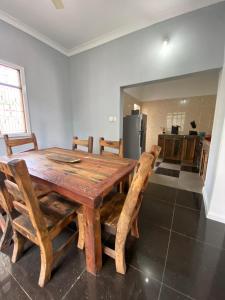 a wooden table and chairs in a room at Pumzika Kendwa Villa in Kendwa