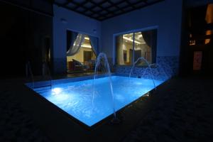 a swimming pool in a house at night at منتجع و شاليهات المخمل Velvet Chalets and resort in Taif