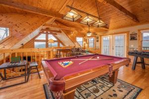 a living room with a pool table in a cabin at OVER THE MOUNTAIN - Smoky Mountain View Cabin in Sevierville