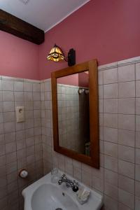 a bathroom with a sink and a mirror and a light at Casa Laiglesia in Uncastillo