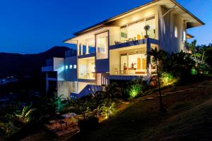 a house on a hill at night with lights at Baan Kuno - Panoramic Views with Total Privacy in Bophut 