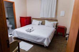 a bedroom with a bed with two towels on it at ZANI APART HOTEL 520i in Porto Velho