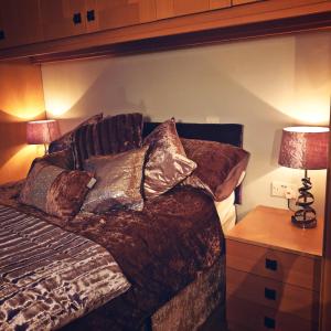 a bedroom with a bed with pillows on it at Bogenraith House in Banchory