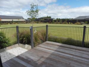 a fence with a wooden boardwalk in front of a field at Deb's Place in Swannanoa