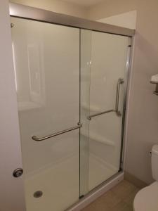 a glass shower door in a bathroom with a toilet at Holiday Inn Express Rolla, an IHG Hotel in Rolla