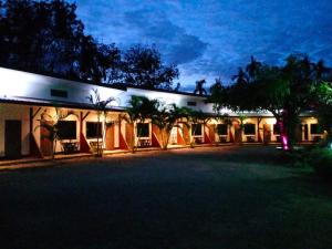 an exterior view of a building at night at Kevin Resort in Thang Kwian