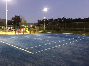 a tennis court at night with a playground at Departamento en Papudo Laguna in Papudo