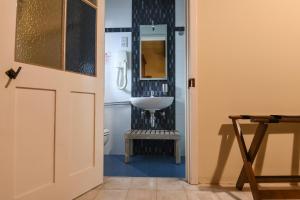 a bathroom with a sink and a toilet at Maria Giovanna Guest House in Marsalforn