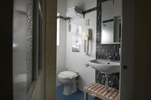 a small bathroom with a toilet and a sink at Maria Giovanna Guest House in Marsalforn