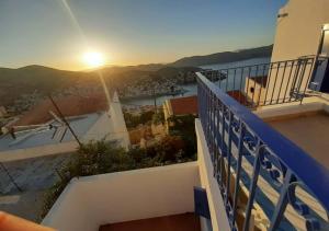 desde el balcón de un edificio con vistas a la puesta de sol en Symi Breeze villa, en Symi