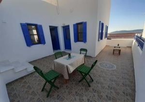a patio with a table and chairs in a building at Symi Breeze villa in Symi
