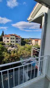 a balcony with a view of a building at Slow motion in Kaštela