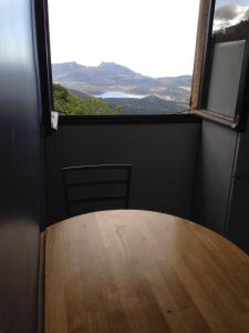 a table in a room with a large window at n6 appartement de Vacancorse Maison U Canale in Speloncato