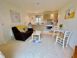 a living room with a couch and a table at Wisteria Cottages are self catering cottages in a beautiful village location in Dorrington