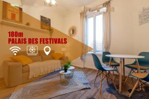 a living room with a couch and a table at Hyper centre cannes 180 mètres plage in Cannes