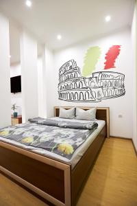 a bedroom with a bed in a room with a wall at Babylon Apartments On Soborna in Rivne