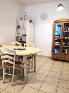 a kitchen with a table and chairs and a refrigerator at Charmante maisonnette au coeur de ville avec balcon - 70 m2 in Sète