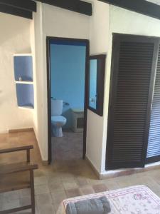 baño con aseo y puerta con ventana en CALA SERENA BEACH 5, en Cala Serena