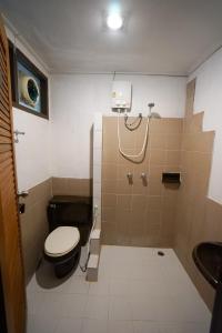 a bathroom with a toilet and a sink at Baan Chai Dan in Thong Pha Phum