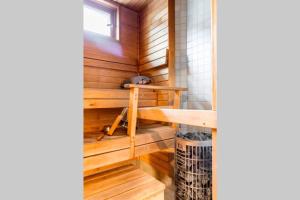 a sauna with wooden walls and a wooden table at Villa Rajaportti 1st&2nd floor Loft with lakeview and free front door parking with electric car plug in Tampere