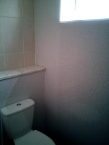 a bathroom with a white toilet and a window at 2 berth first floor flat Apsley 4 in Great Yarmouth