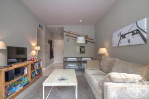 a living room with a couch and a table at BICIBERRI de Alma de Nieve in Baqueira-Beret