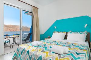 a bedroom with a bed with a view of the ocean at marina beach in Livadia