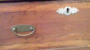 a metal object on a wooden floor next to a knife at S'Attobiu B&B And Guest-Houses in Teulada