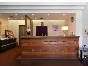 a lobby with a stone fireplace in a room at Sapporo Clark Hotel in Sapporo