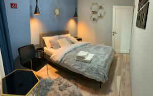 a bedroom with a bed and a chair with two books on it at Matteo apartment in Iaşi