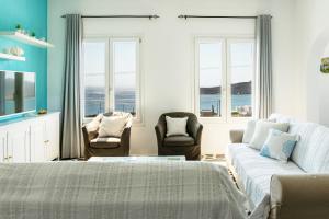 a living room with two beds and a couch at Villa Tani in Agios Georgios +55 photos