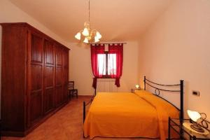 a bedroom with a bed and a red window at Agriturismo Villa Martis in Passignano sul Trasimeno