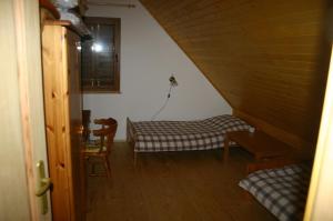 a room with a bed and a table in a attic at Villa Dalski in Piechowice